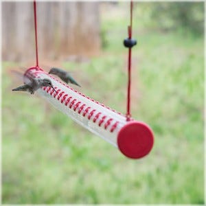The Hummerbar® is a patented horizontal hummingbird feeder which allows multiple hummingbirds to feed at once.