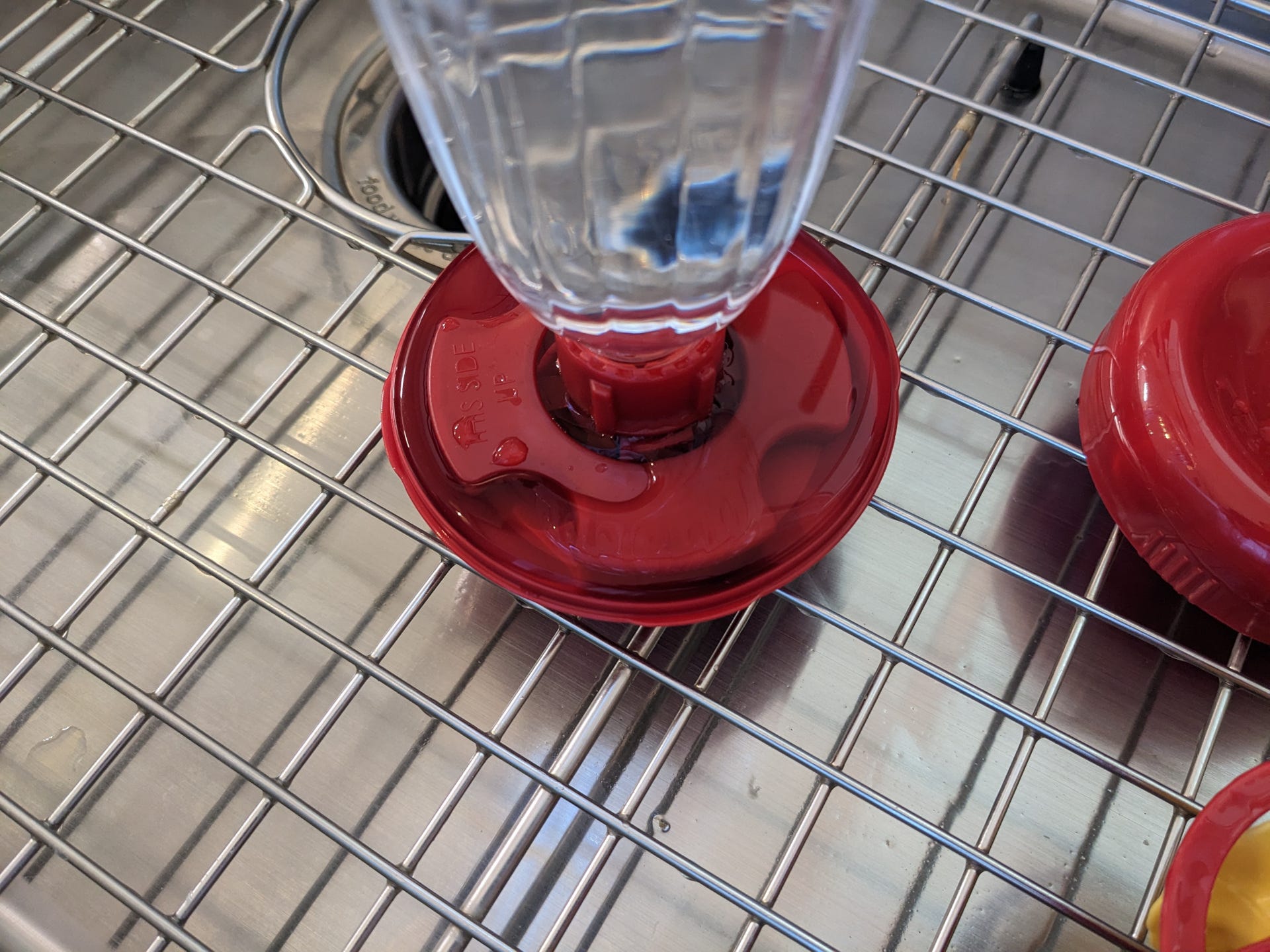 A real photo of  Perky-Pet® Yellow Petunia Top Fill Plastic Hummingbird Feeder by S (1)